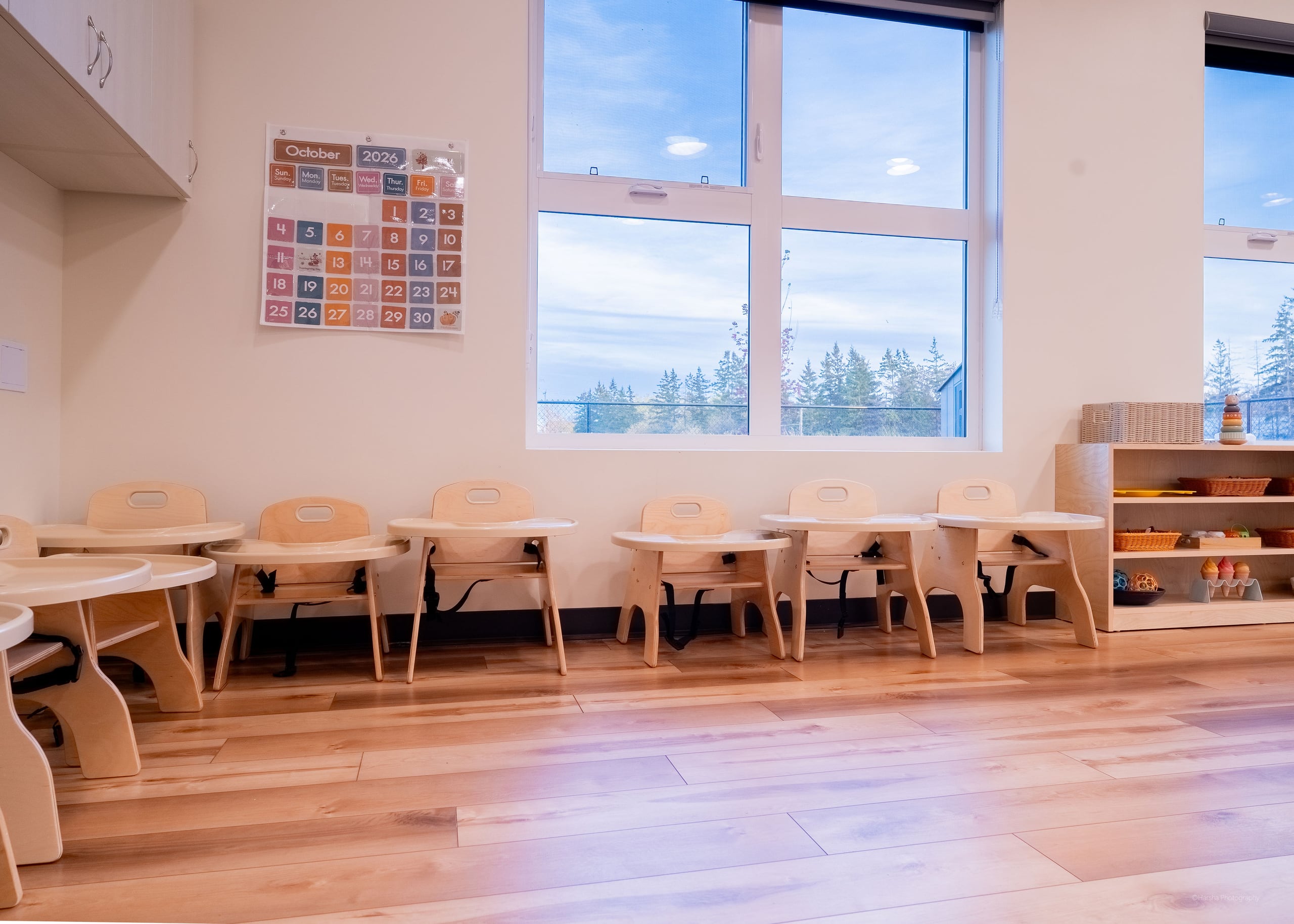 Child-sized tables under tall windows