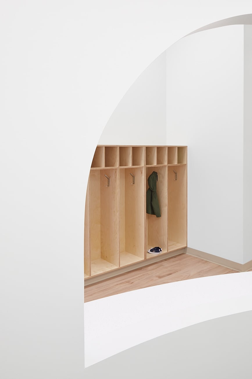 Cubbies through a welcoming arch